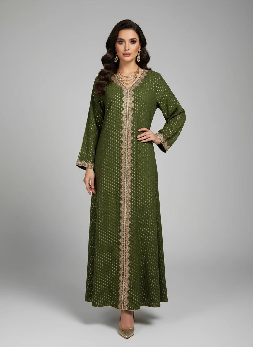 Green dress with beige pattern on a mannequin against a white paneled wall.