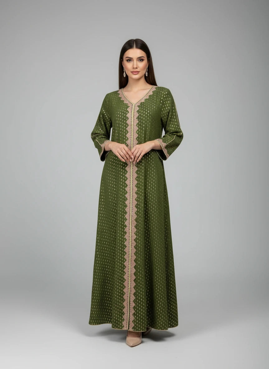 Green dress with beige pattern on a mannequin against a white paneled wall.