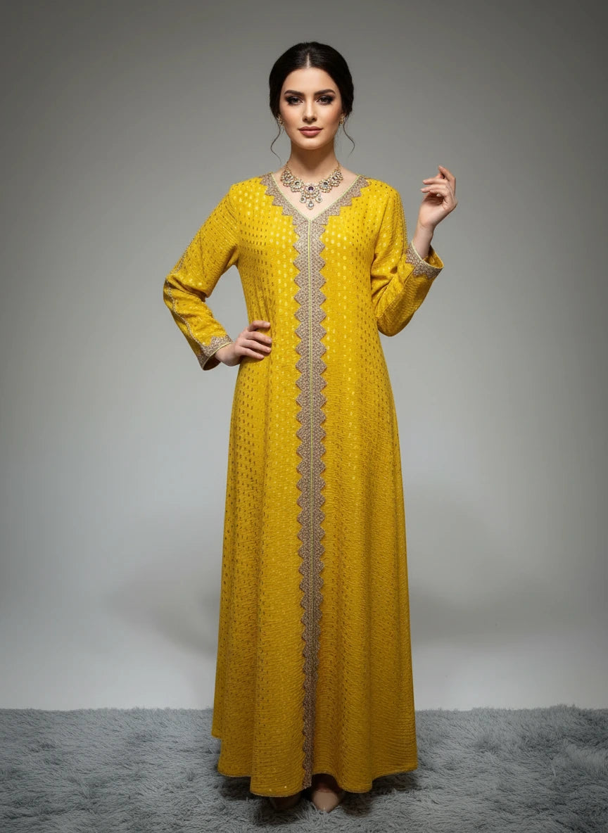 Yellow dress with intricate detailing on a mannequin against a white paneled wall.