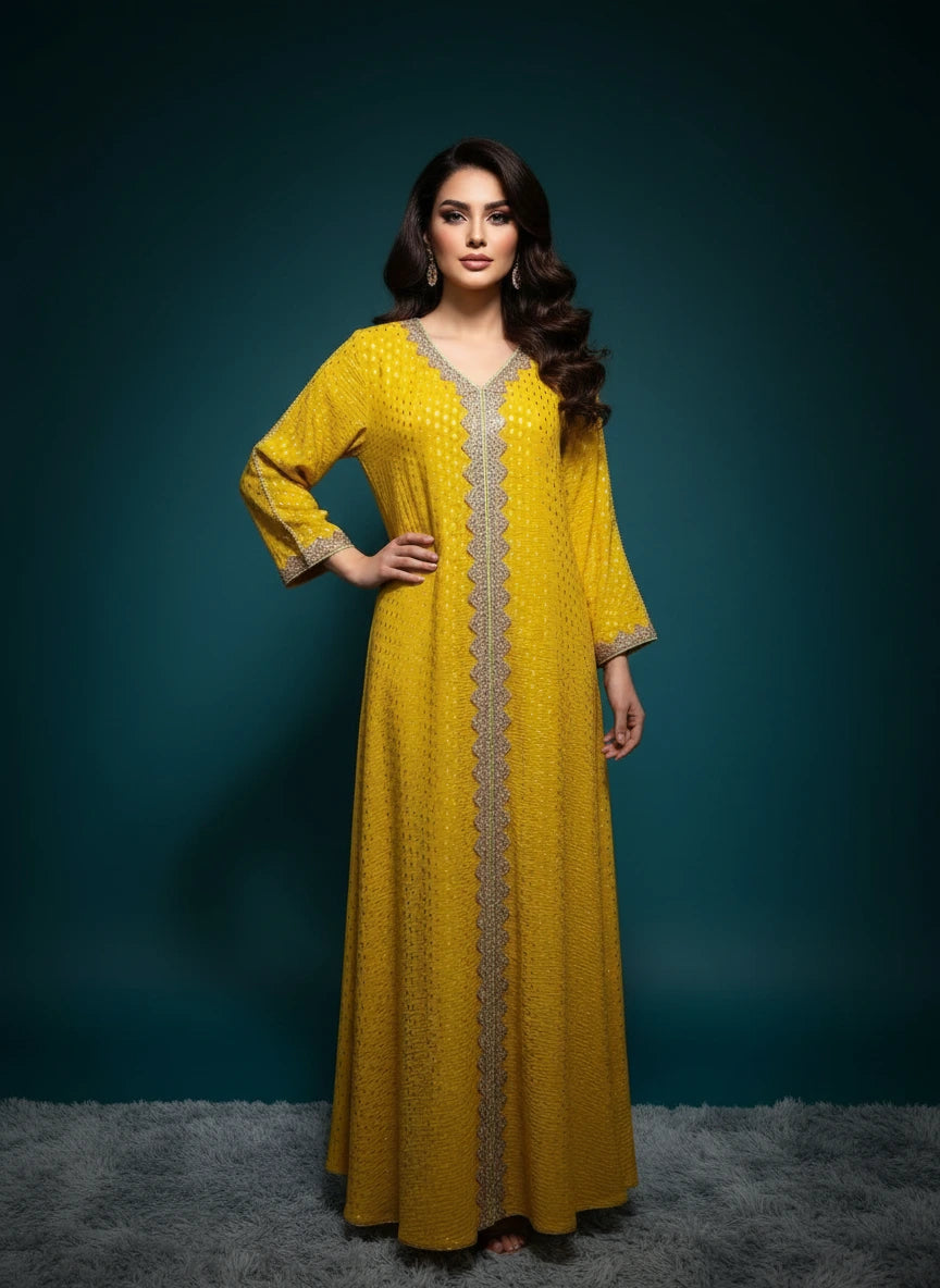 Yellow dress with intricate detailing on a mannequin against a white paneled wall.