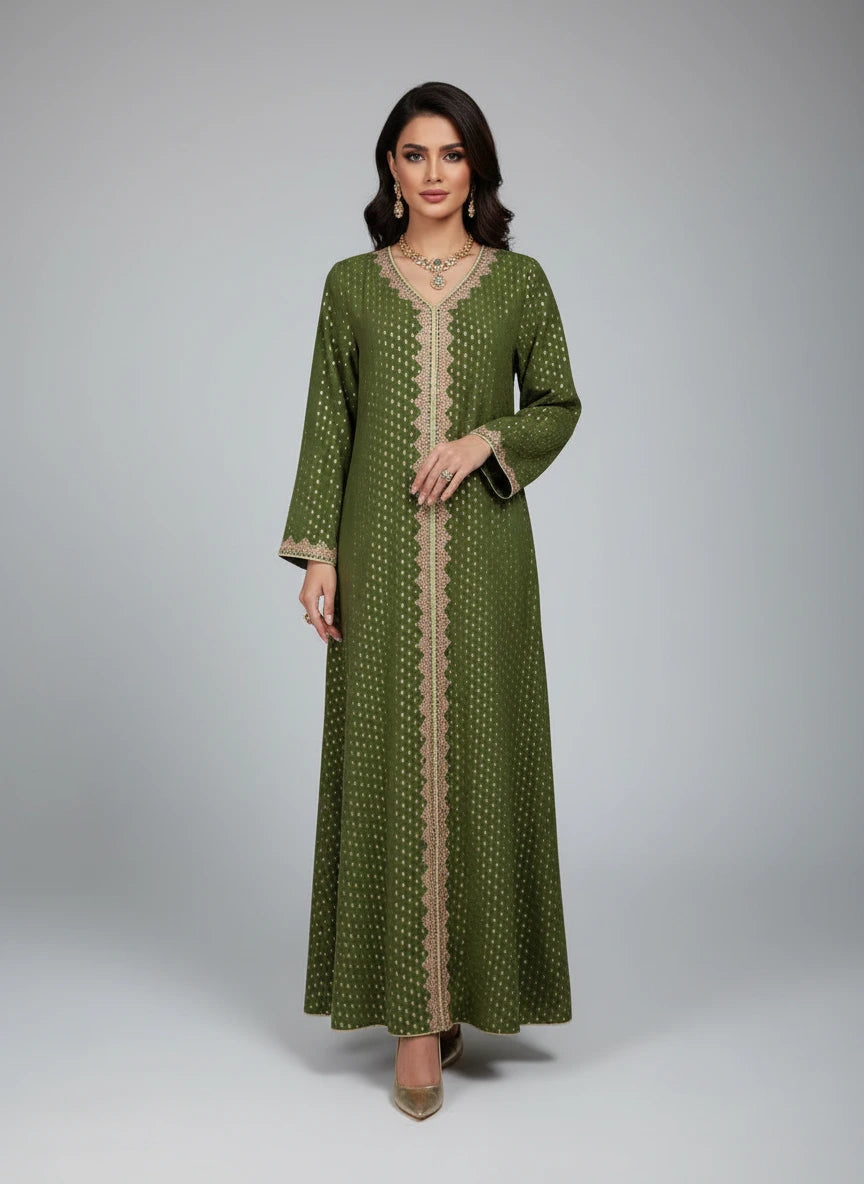 Green dress with beige patterns on a mannequin against a white paneled wall.