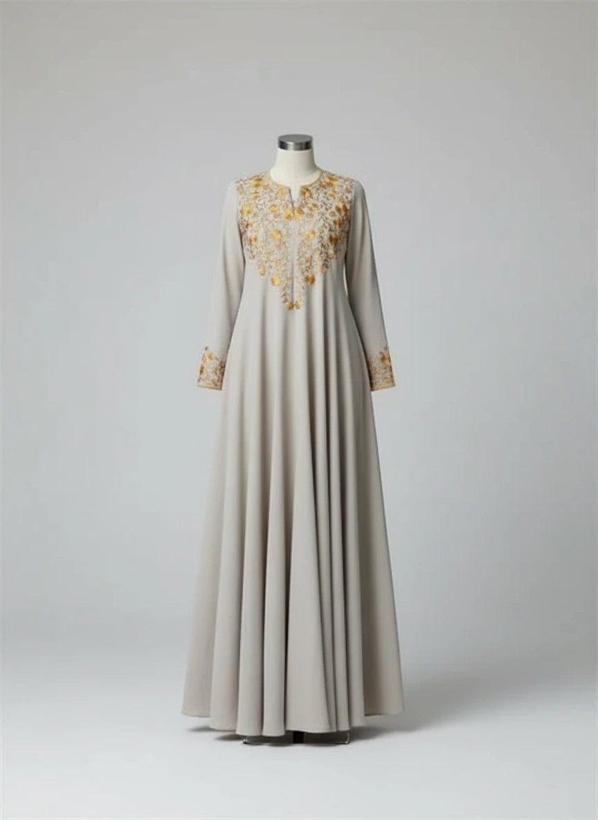 Long dress with gold embroidery on a mannequin against a white background