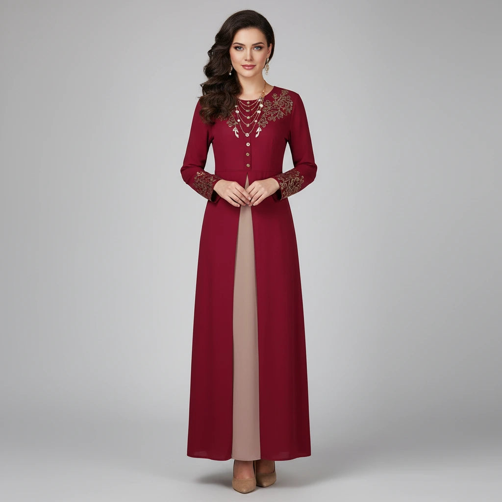 Woman wearing a long burgundy dress with lace details on a gray background