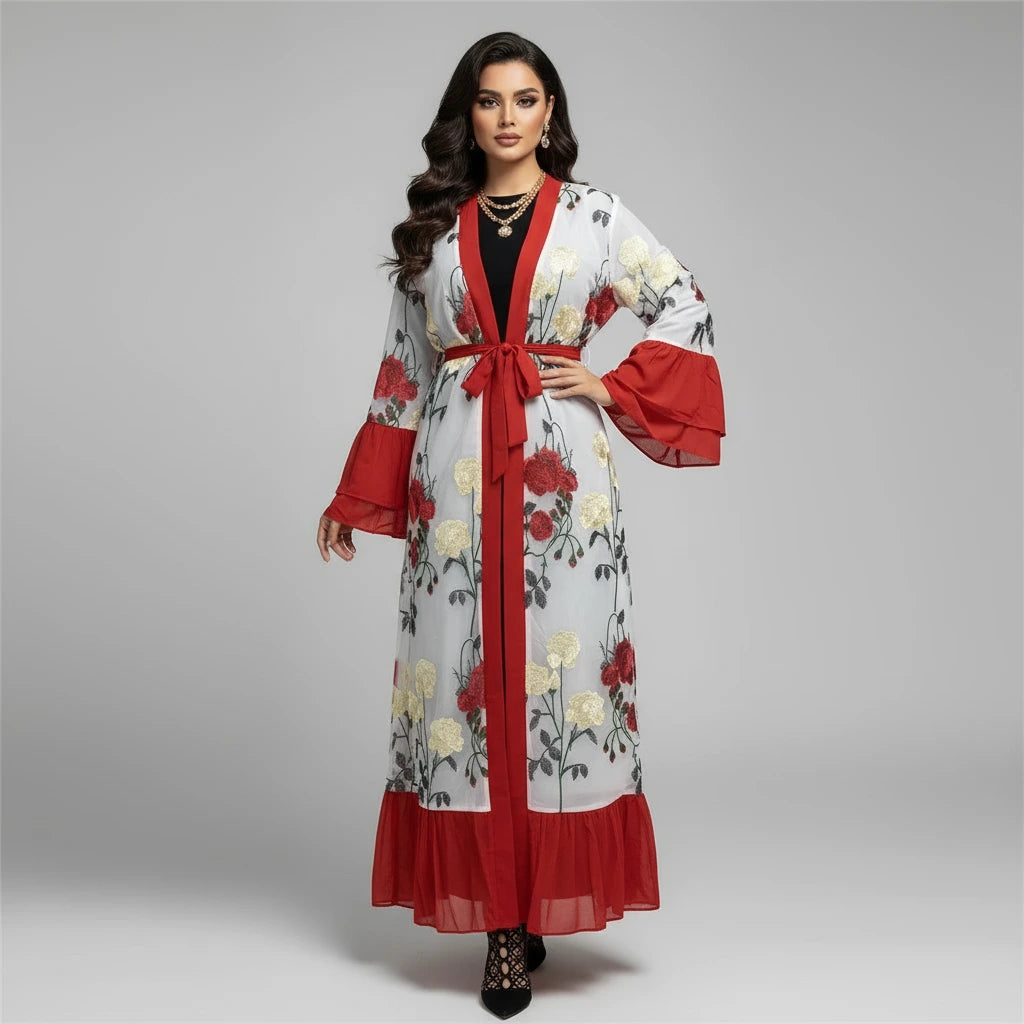 Woman wearing a floral robe with red accents in a living room setting.