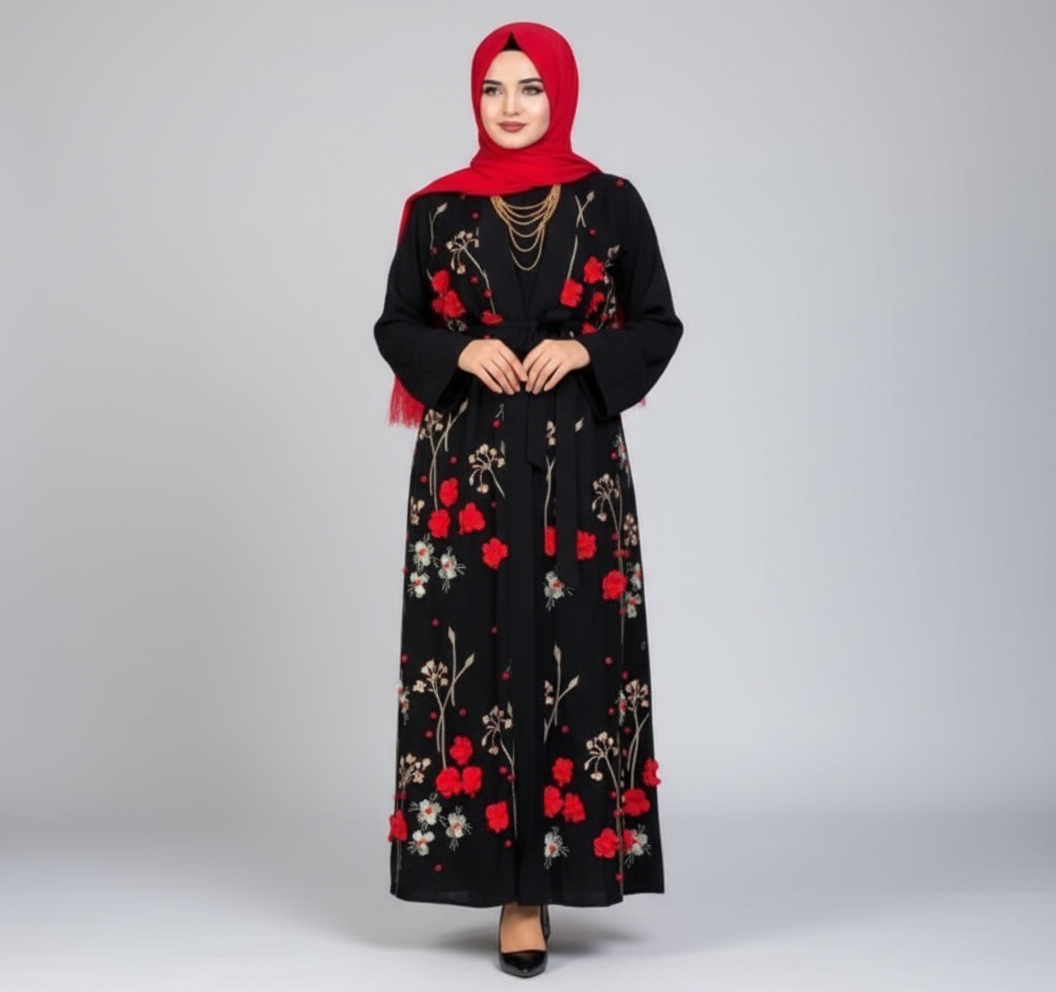 Woman wearing a black floral dress with red hijab in front of a blue door.