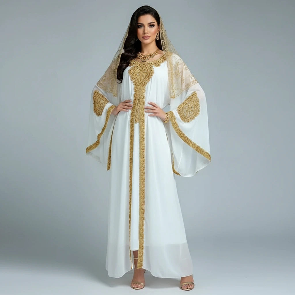 Woman wearing a white dress with gold embroidery on a gray background