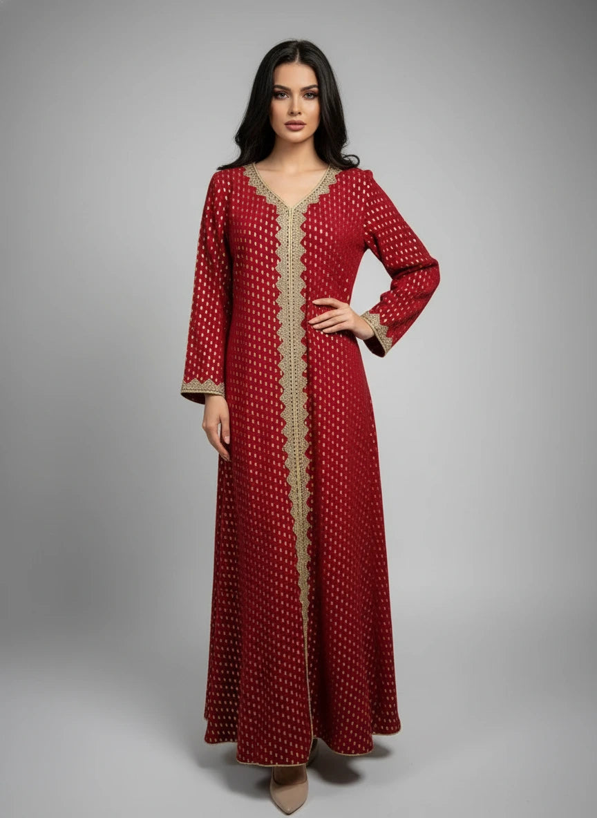 Red dress with gold detailing on a mannequin against a white paneled wall.