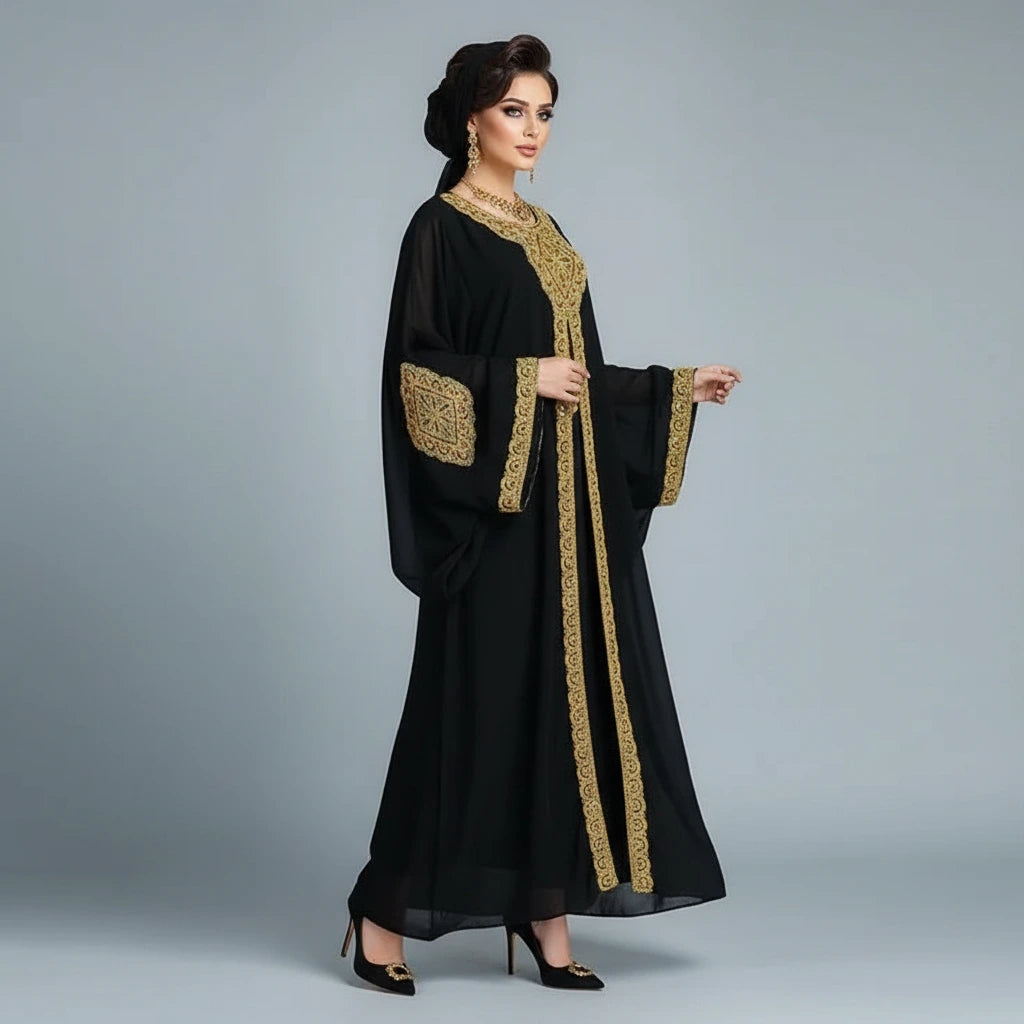 Black abaya with gold embroidery on a mannequin against a gray background