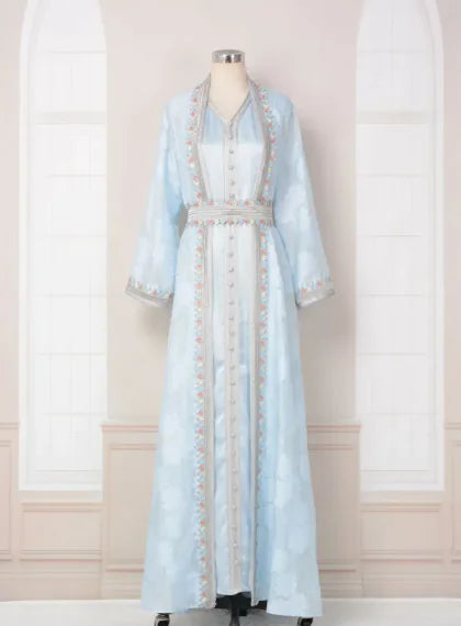 Light blue dress with intricate detailing on a mannequin against a neutral background