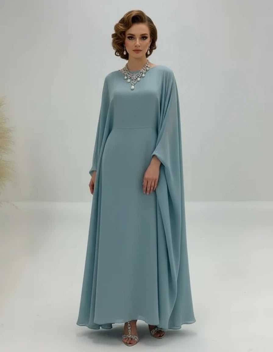 Woman wearing a light blue dress with a cape on a white background