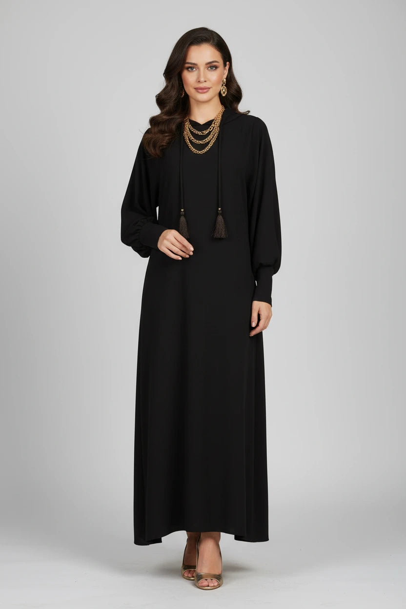 Black abaya on a hanger against a white background