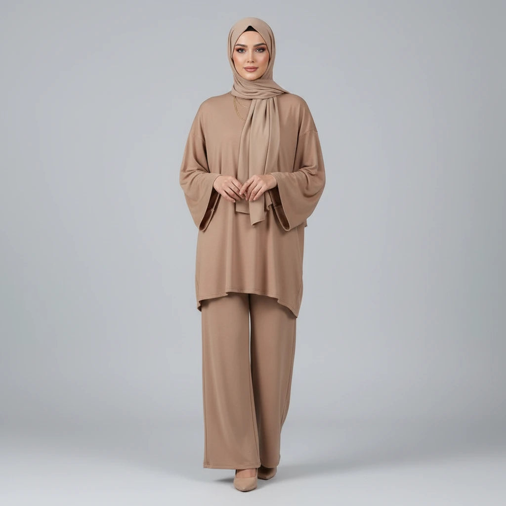 Woman wearing a beige outfit with hijab on a gray background