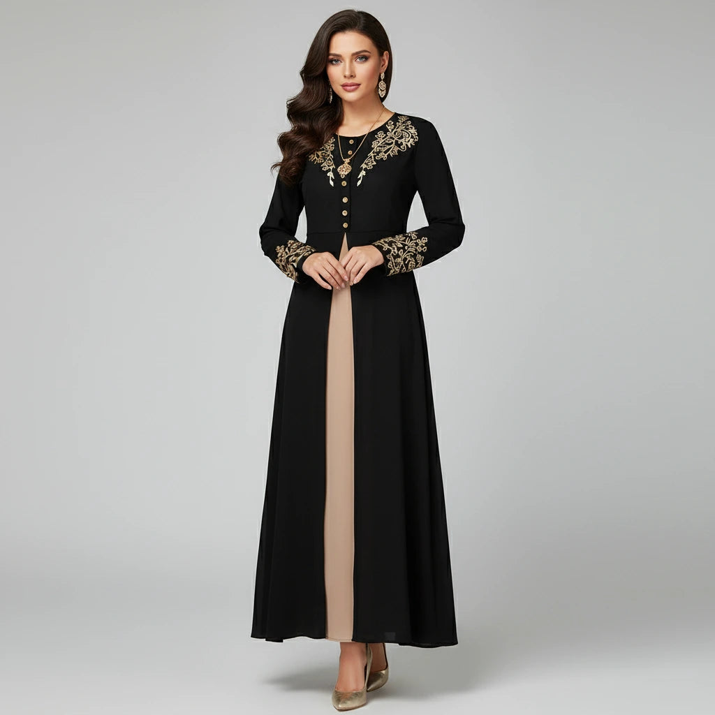 Woman wearing a black dress with gold embroidery on a gray background