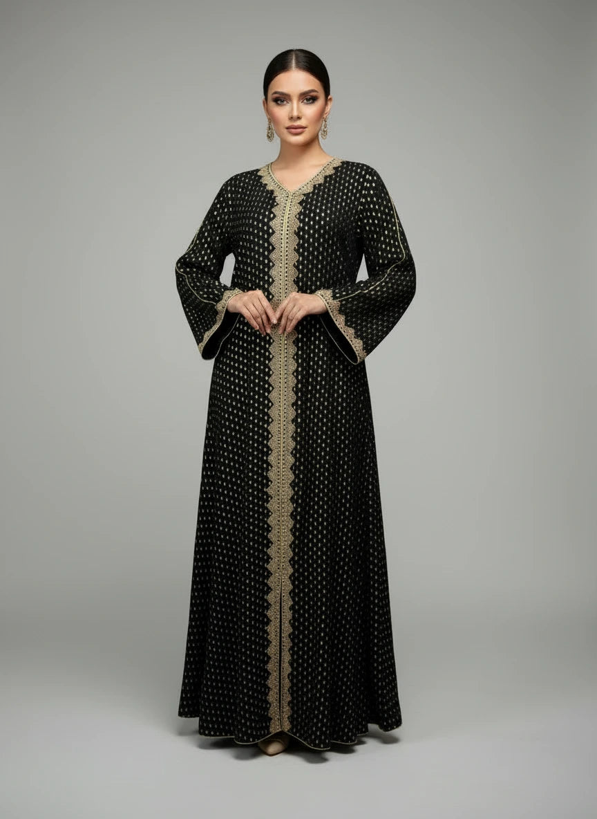 Black patterned dress on a mannequin against a white paneled wall.