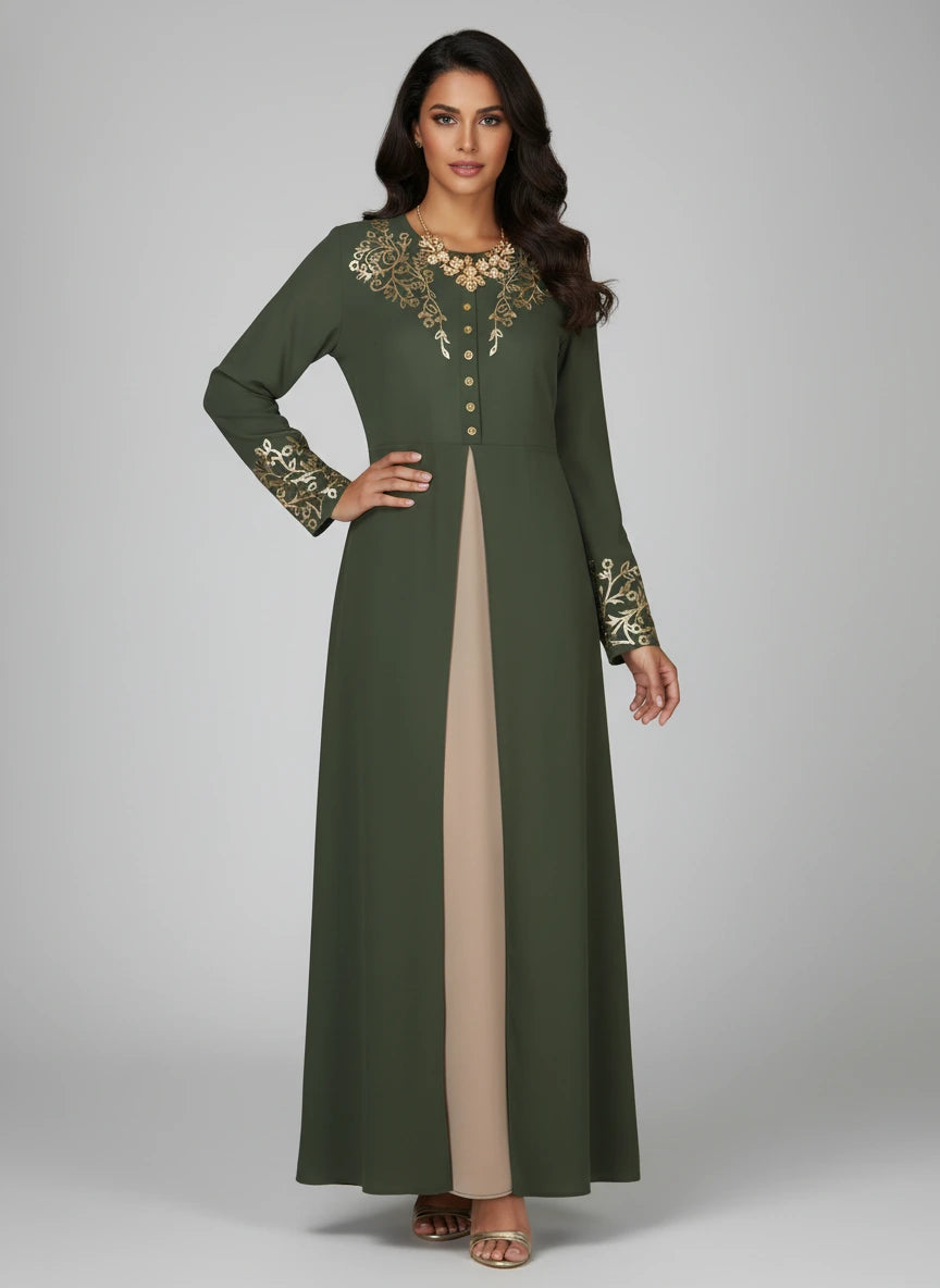 Woman wearing a green long dress with gold embroidery on a gray background