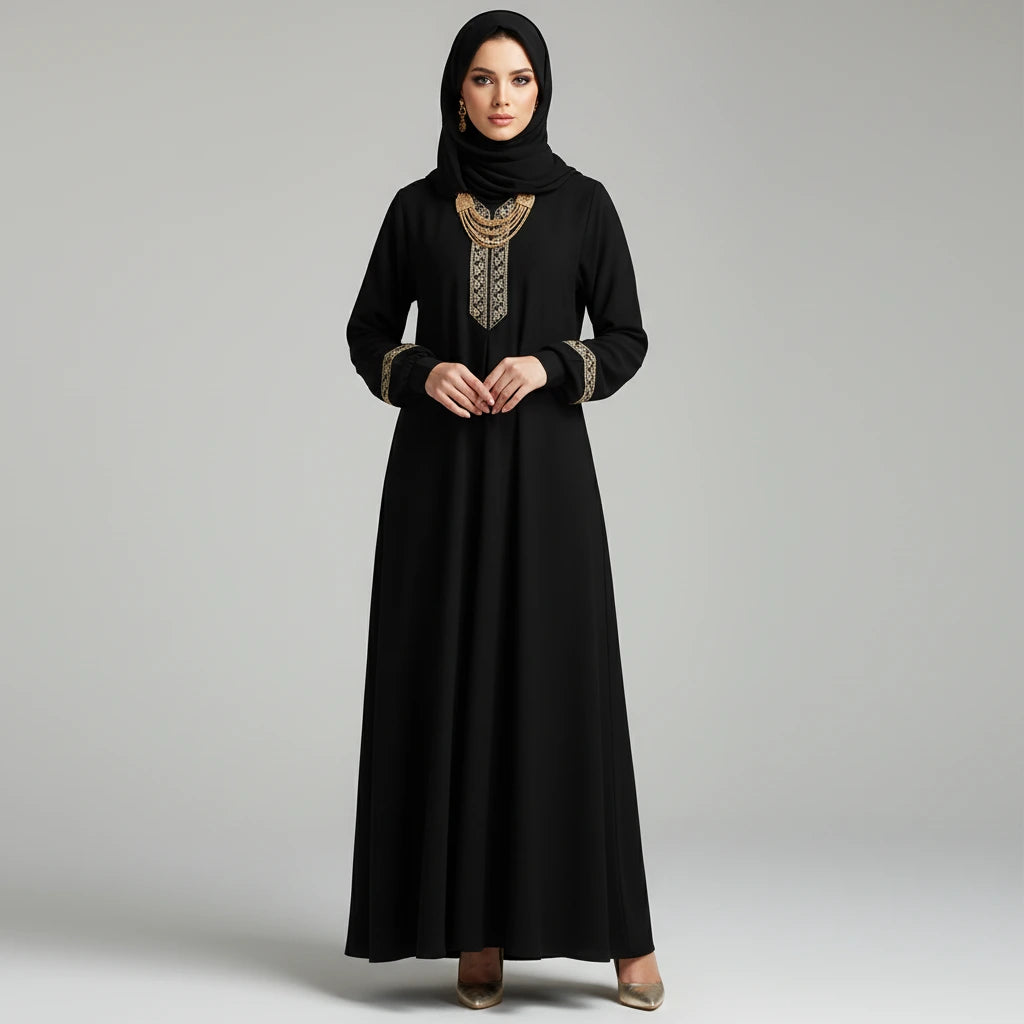 Woman wearing a black abaya with gold embroidery on a gray background