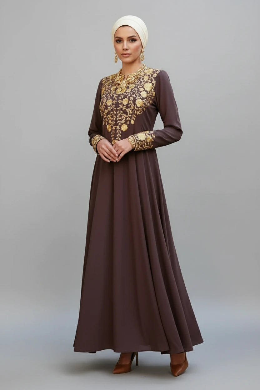 Woman wearing a brown dress with gold embroidery on a gray background