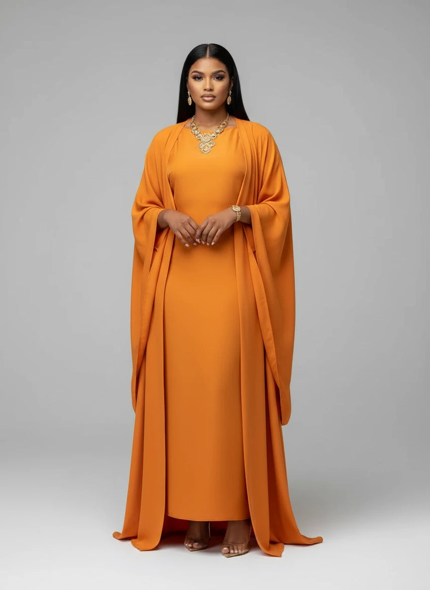 Woman wearing an orange dress with a plain background