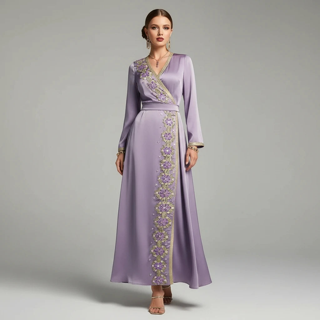 Woman wearing a long purple dress with floral embroidery on a gray background
