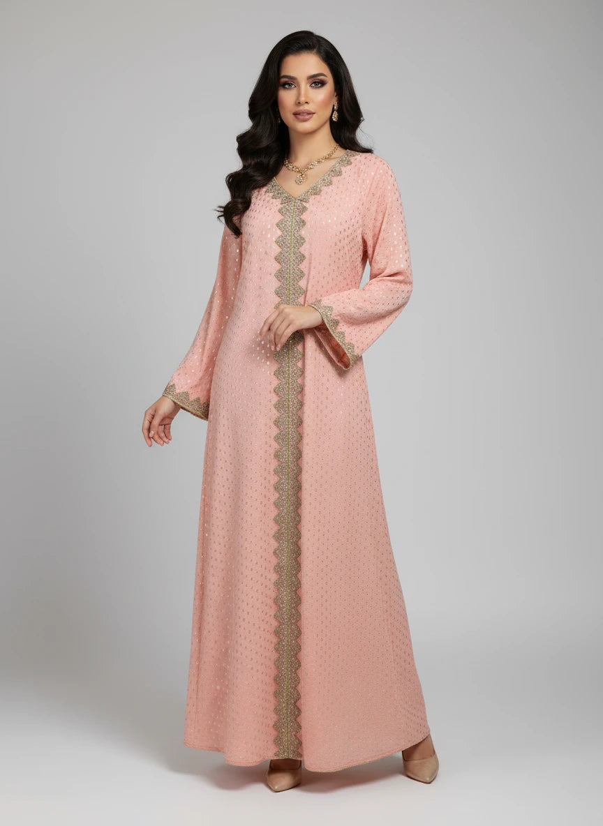 Peach-colored dress with gold embroidery on a mannequin against a white paneled wall.